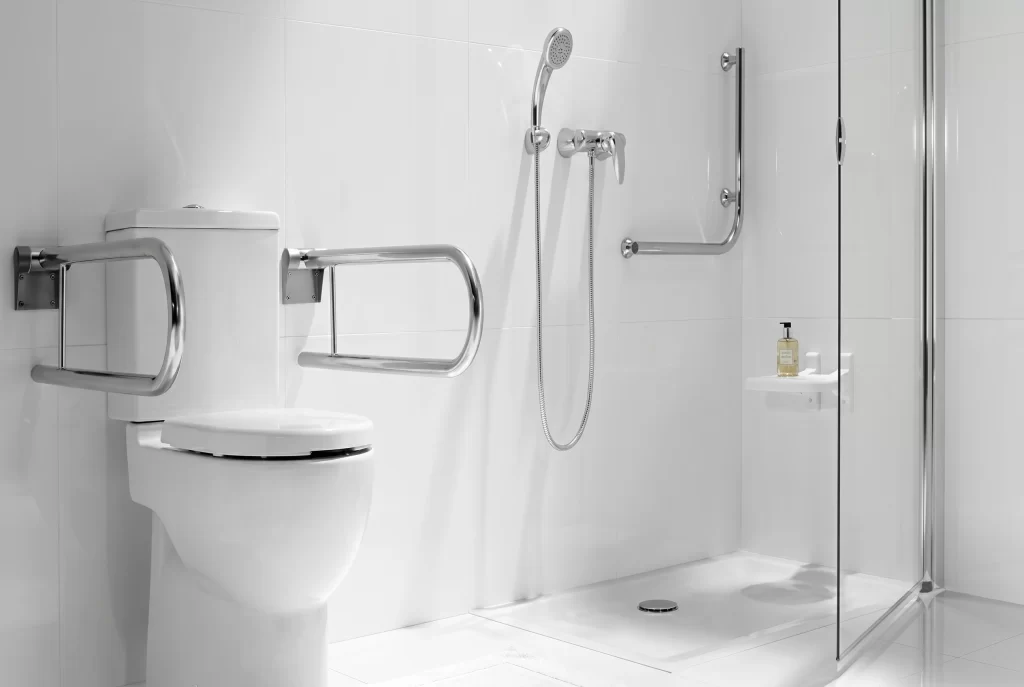 Accessible bathroom with grab bars and roll-in shower for guests with reduced mobility.