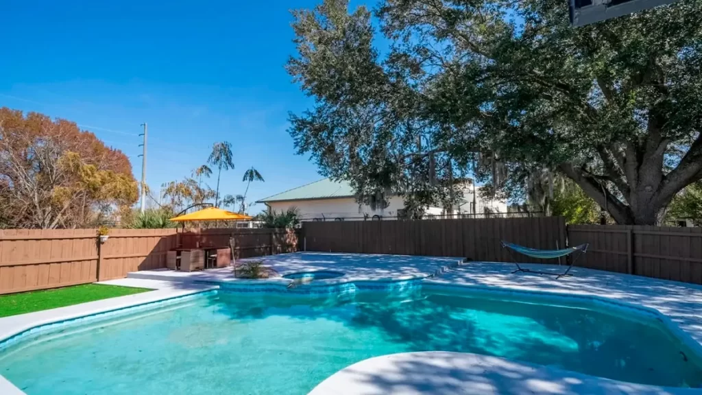 Private pool with jacuzzi and hammock at a vacation home in Paradise Palms Kissimmee.